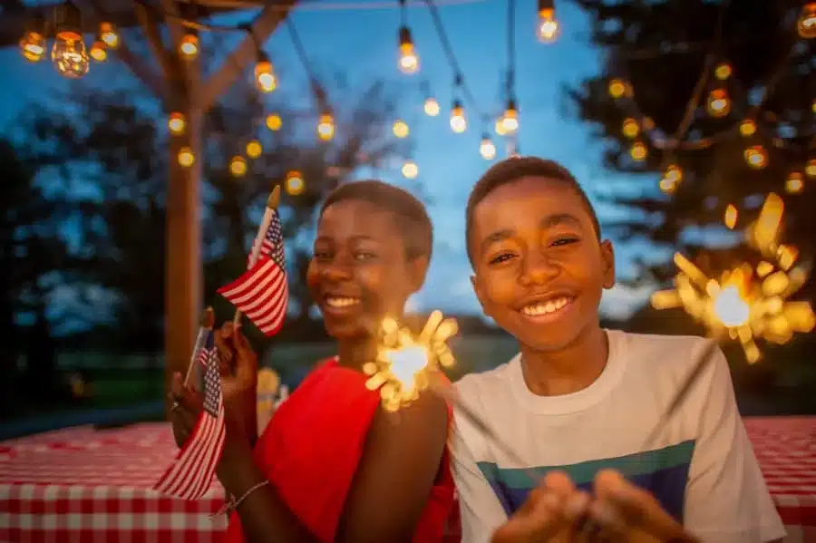 Two kids celebrating 4th of July in backyard