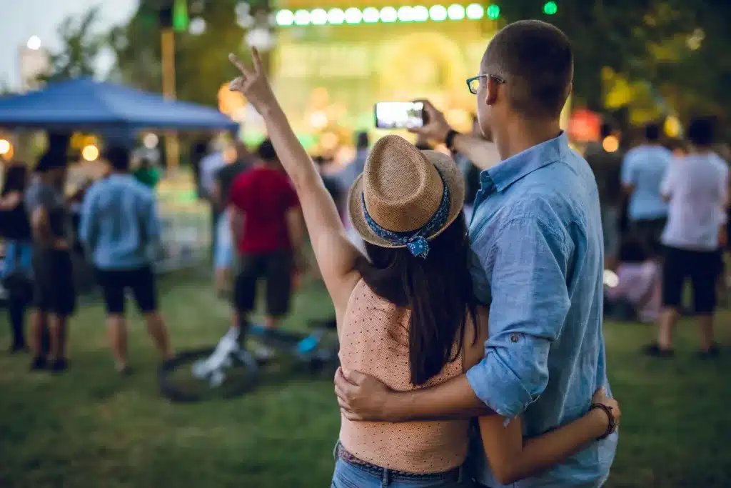 Couple taking selfie at outdoor concert